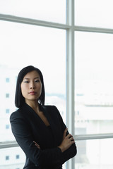 Businesswoman with arms crossed, looking at camera