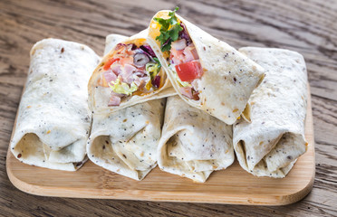 Chicken burritos on the wooden background
