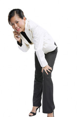 Woman with mobile phone, bending forward