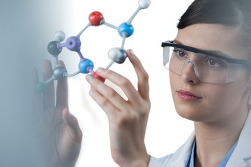 Female scientist holding molecular model