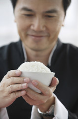 Man holding bowl of rice