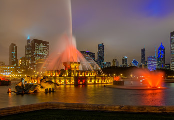 Chicago skyline panorama with skyscrapers and Buckingham fountain in Grant Park at night lit by...