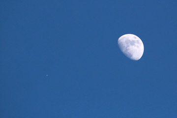 Day Moon with Planet in a Bright Blue Sky