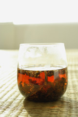 Glass of Chinese Tea on woven mat
