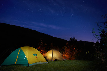 Illuminated yellow camping tents