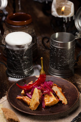 Against the backdrop of a still life of a medieval