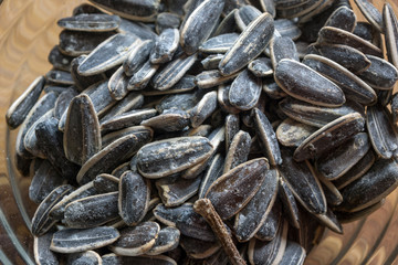 Grilled sunflower seeds with sea salt and spices on the wooden background