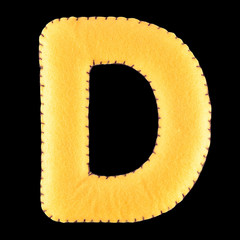 D- letter from yellow felt. Collection of colorful handmade English alphabet isolate on black...