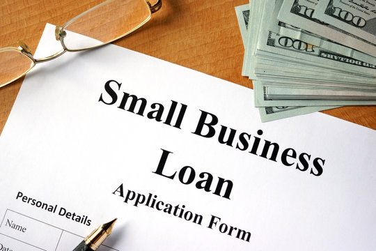 Small business loan form on a wooden table.