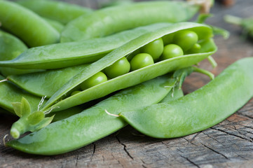 pods green pea on an old wooden table