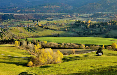 Fototapeta na wymiar Fall in Slovakia. Meadows and fields landscape. Autumn color trees.