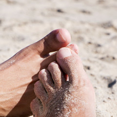 men playing footsie on the beach