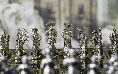 Metal chess. Beautiful and unusual chess pieces. Vintage background.