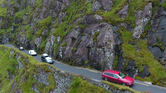 Cars travelling on the small road in SkyRoad a one way road going up the mountain in Ireland