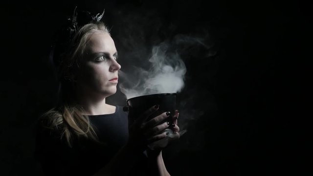 Dark portrait of evil witch with bowl. 4K UHD
