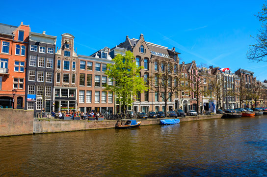 Traditional old buildings and and boats in Amsterdam, Netherlands