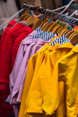 Fototapeta premium Bright raincoats hanging at a fashion store