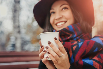 woman with a mug of coffee or tea in the winter outdoors