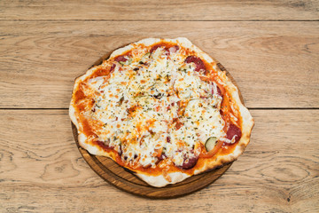 Italian pizza with pickles salami and cheese