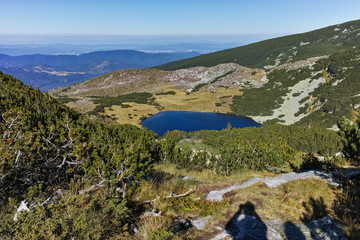 Fototapeta na wymiar Landscape with green hills and Yonchevo lake, Rila Mountain, Bulgaria