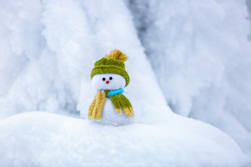 Nice dreaming snowman in green hat.