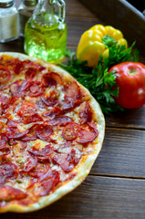 Tasty pizza with vegetables and sausage
