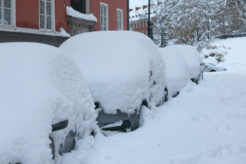 Snow chaos in the traffic. Cars covered with snow