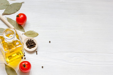 olive oil in jar on wooden background with spices