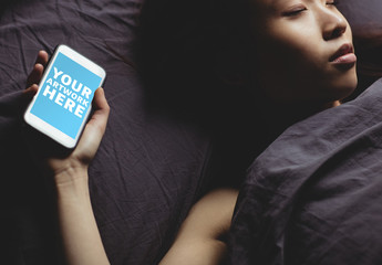 User with Smartphone Asleep in Bed Mockup