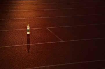 Bottle on athletics track before morning run