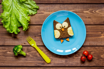 kids breakfast owl shaped sandwich on blue plate top view