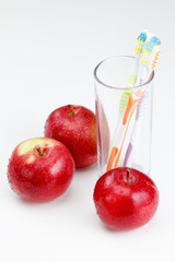 apple with a toothbrush, on white. dental care concepts