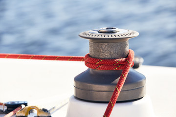Sheet on the winch on a yacht on the background of blue water