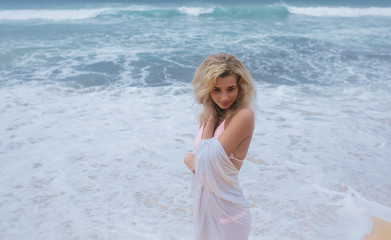Fototapeta na wymiar Beautiful young woman on beach