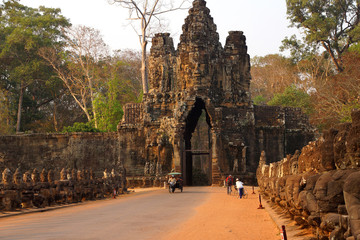 Motorbikes and Tuk tuks leave Angkor Thom