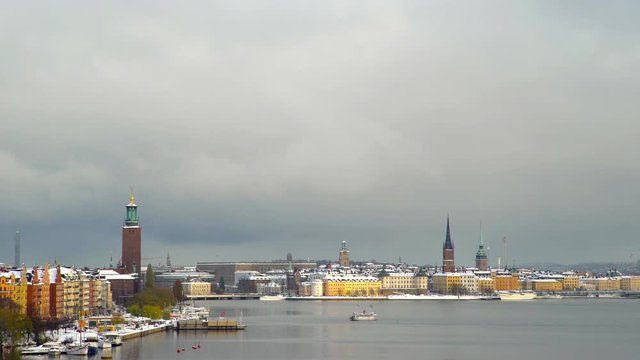 Stockholm covered in snow with a public ferry crossing the bay.
