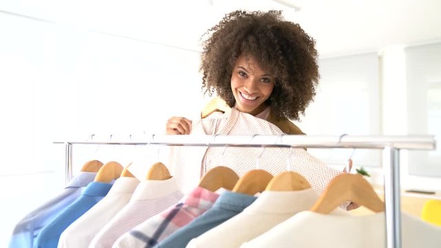 Mixed-race woman shopping in clothing store