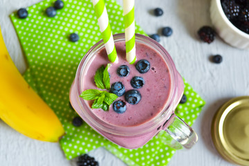 Smoothie with banana, blackberries and blueberries in the bank 