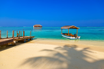 Boat and bungalow on Maldives island