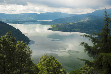 Obraz premium Landscape with lake Amatitlan in mountains in a cloudy day. Guatemala