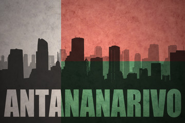 abstract silhouette of the city with text Antananarivo at the vintage madagascar flag