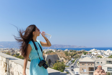 Fototapeta na wymiar Elegant girl visiting Venetian walls Heraklion, Crete, Greece.