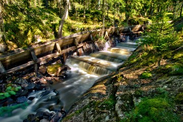 Old timber rafting facility and waterfall in the Swedish woods
