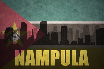 abstract silhouette of the city with text Nampula at the vintage mozambican flag