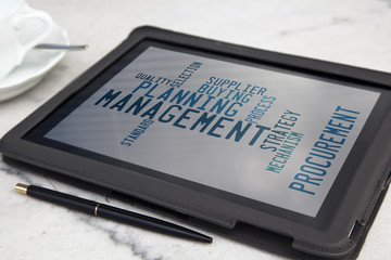 tablet with management word cloud