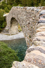 Fototapeta na wymiar Small ancient stone bridge