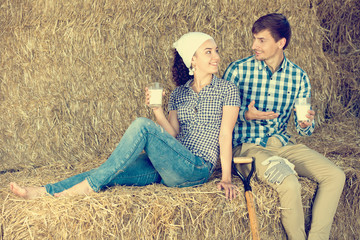Naklejka na ściany i meble couple in the hay with milk