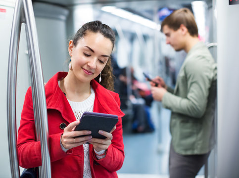 Subway Passengers Busy With Gadgets