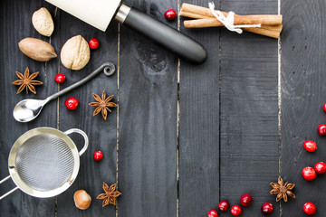 Baking ingredients on the dark rustic wooden background. Top view. Christmas theme. New year menu.
