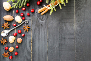 Christmas theme. Baking ingredients on the black wooden background. Rustic style.